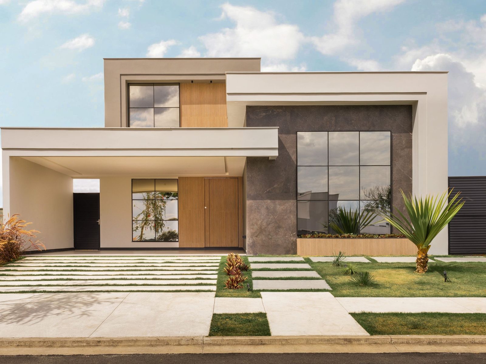 Modern two-story house with a flat roof and landscaped front